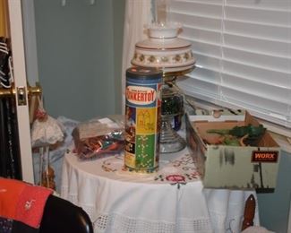 Table with Antique Oil Lamp with Milk Glass Globe, TinkerToys in original box, bag of Lincoln Logs and box of Vintage Toy Soldiers and Military Vehicles, beautiful Table Covering and More!