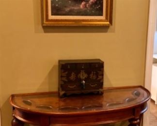 Quilts, demilune console table, framed art