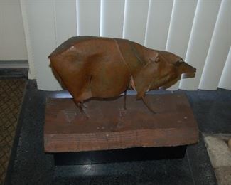 Metal pig on wooden base