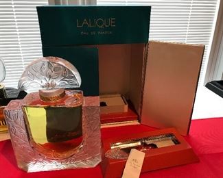 Lalique 20 oz perfume Factice? complete with box and matching Lalique pendant.