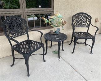 Iron patio chairs and side table with metal fish statue