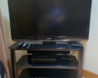 Flat screen TV and Innovex tempered glass audio/TV/media stand