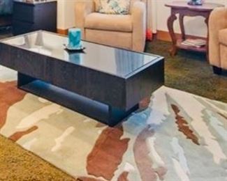 Contemporary black enameled coffee table and abstract rug