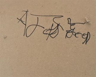 Artist’s signature on back side of table