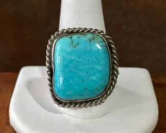 #7...Nice size 13 Native American made ring with large almost square shaped turquoise cabochon with rounded corners. The cab is set in a smooth bezel and framed on the outer edge with silver twisted rope-style wire. Split shank band. $180