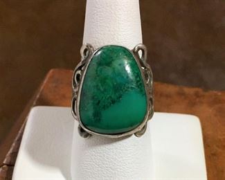 #101...Beautiful size 8 1/2 - 8 3/4 silver ring with triangular-shaped green turquoise cabochon surrounded by silver curly cue framing. $150