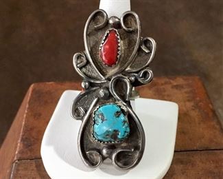 #17...Fabulous size 8 3/4 large old pawn Native American made ring. Featuring a turquoise nugget and a coral cabochon set in sawtooth bezels and surrounded by fantastic large silver curly cues plus five silver raindrops. $250