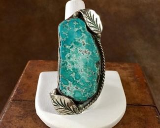 #22...Fantastic size 8 3/4 Native American made ring with a stunning huge turquoise slab (3/4" x 1 3/4"!) framed on one side by silver twisted wire and by a leaf and two rain drops on the top and bottom. Split shank band. $320