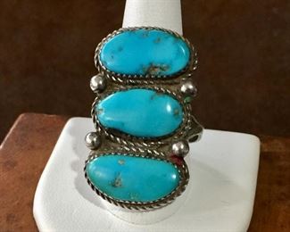 #5...Beautiful Native American made silver ring with three gorgeous large oval-shaped turquoise cabochons (top and bottom cabs have pyrite flecks). Finished with four silver rain drops and twisted wire framing on outer edges. Split shank band. $320