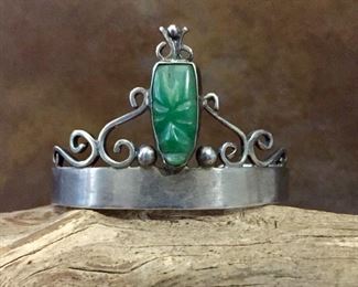 #25...Signed Mexico sterling silver cuff bracelet with carved green onyx cabochon. Size of framed green onyx face cabochon including "crown" is 3/8" x 1 1/8". Total circ. 6 1/2" (5 3/8" inner circ. with 1 1/8" gap). Signed CMA and stamped MEXICO SILVER HANDMADE. $180