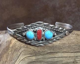 #46...Native American made sterling silver, turquoise and coral cuff bracelet. Width tapers from 3/4" at front center to 3/16" in back. Total Circ. is 6 5/8" (5 3/8" inner circ. with 1 1/2" gap). Stamped STERLING. Flexible. $180