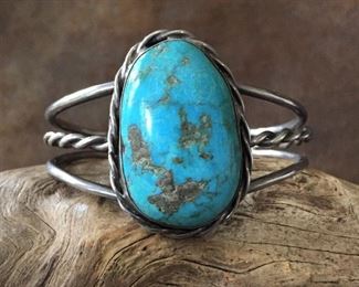 #32...Native American old pawn sterling silver and turquoise cuff bracelet. Featuring a huge gorgeous egg-shaped turquoise cabochon (1 1/16" x 1 5/8" framed size). Width tapers from 1 5/8" at height of framed cabochon to 5/16" in back. Total circ. 6 5/8 " (5 1/4" inner circ. with 1 3/8 " gap). Slightly flexible. $380