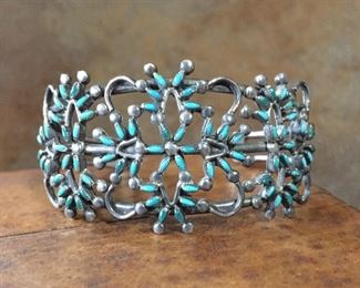 #16...Native American made turquoise and sterling silver needlepoint cuff. Beautiful piece with many different colors of turquoise. Tapered width from 1 1/4" at front center to 5/16" in back. Total circ. 6 3/8" (5 1/4" inner circ. with 1 1/8" gap). Not flexible. $580