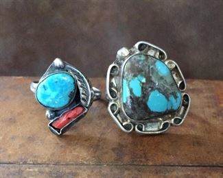 #54...Native American silver rings: (1) Size 10 ring with turquoise and coral cabochons decorated with silver feather and rain drops. $150 (2) Size 6 old pawn ring with turquoise cabochon surrounded by silver curlicues and a silver rain drop. $130
