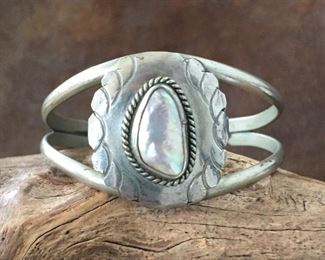 #49...Mexico sterling silver cuff bracelet. Center pearl cabochon has a gorgeous iridescent nacre. Width tapers from 1 5/16" (center front) to 5/16" in back. Total circ. is "6 7/8" (5 3/8" inner circ. with 1 1/2 " gap). Stamped 925 HECHO EN MEXICO. Slightly flexible. $250