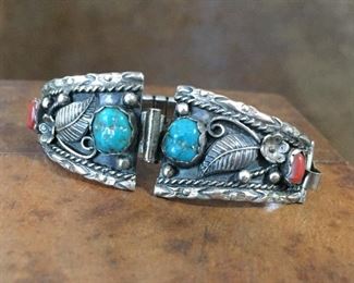 #61...Signed sterling silver watch tips with coral and turquoise, signed JM, stamped STERLING, size 3/4" x 1 1/8". Decorated with flowers/raindrops/leaves (flower is beside coral cabochon). $120