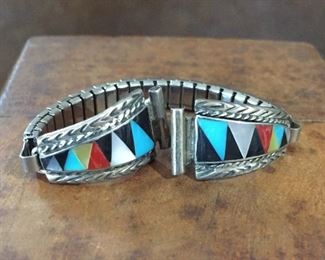 #65...Signed sterling silver watch tips with an all-inlay design of coral, turquoise, onyx and mother of pearl, signed JM, stamped STERLING. Size 5/8" x 1". $120