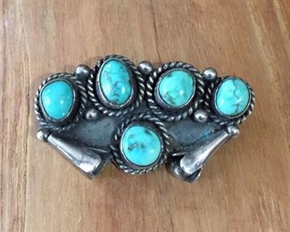 #71...Signed Native American made sterling silver brooch decorated with five beautiful turquoise nuggets, sterling rain drops, twisted rope style wire and two squash blossoms. Size 1 7/8" x 1", signed NAC-Z on back. $220