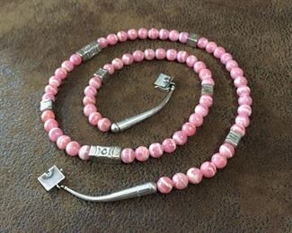 #72...Gorgeous 28" long Native American made sterling silver and rhodochrosite necklace. Featuring gorgeous, super high quality rhodochrosite 8mm beads and seven handmade stamped sterling silver bench beads. Finished with sterling cones and box clasp with safety latch. Stamped 925. $480