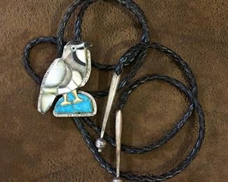 #83...Gorgeous Native American made bolo. Fabulous mosaic stone inlay in a bird motif, stones include turquoise, onyx and several shades of mother of pearl. Masterful craftsmanship includes precisely cut inlays with additional scribed detailing on almost all inlay pieces. Bolo tie is 46" black leather with silver tips. $380