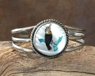 #85...Zuni sterling silver cuff bracelet with an eagle composed of turquoise, onyx and mother of pearl inlays. A very fine example of Zuni artistry and craftsmanship. Total circ. 5 1/2" (4 1/4" inner circ. with 1 1/4" gap). Size of framed cabochon is 1" diameter. $240
