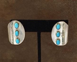 #103...Navajo sterling silver hand stamped pierced earrings each with three beautiful turquoise cabochons set in sawtooth bezels. Stamped STERLING on back. Size 1 1/8" x 3/4". $160
