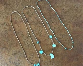 #109...(LEFT) Liquid silver 14 1/2" necklace with sterling beads and three small turquoise beads. Hook and eye clasp, $70. (CENTER) Liquid silver 14 5/8" necklace with sterling silver tube beads and five turquoise beads with screw clasp, $70. (RIGHT) Liquid silver 15 3/4" necklace with sterling silver tube beads and turquoise-colored glass beads with screw clasp. $65