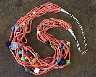 #26...Vintage Native American 10-strand genuine coral "treasure" necklace loaded with all kinds of beads including African and Venetian trade beads, carved wood, art glass, seeds, turquoise, vaseline glass and even a 1927 liberty dime! Length flexible from 24 1/2" - 26 3/4". $1400