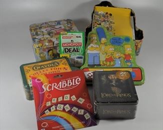 2 Simpson's Tria Game sets, a Scrabble refrigerator magnet game, a Monopoly gards game, Lord of the Rings Action Flipz cards, and Crayola Collectors Colors (72): $30