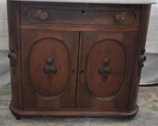 Victorian walnut marble top stand. Piece of molding on bottom right side - piece mostly there. There are holes in the back of the marble top where a another piece was attached. These are easily covered by candlesticks, etc. 32" x 18 1/2" x 29": $125