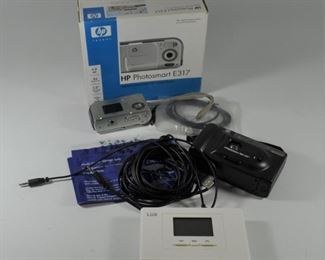 HP PhotoSmart E317 camera with photo paper: $10. Minolta Freedom 50 camera (uses film): $10. Lax Thermostat: $5