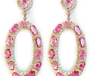 A PAIR OF PINK SAPPHIRE AND DIAMOND EARRINGS
An oval set of 18K rose gold earrings filled with 12.62 carats of natural rose cut pink sapphires, each surrounded by a total of 10.82 carats of diamonds.