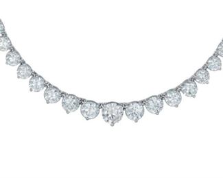 A DIAMOND RIVIERA TENNIS NECKLACE, 13.60 CARATS
Riviera 18KT white gold and diamond tennis necklace features a total 13.60 carats of diamonds all around, increasing in size as they reach the front of the necklace. Very attractive. Natural untreated diamonds, the white diamonds near colorless white.
