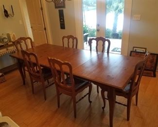 CLEAN large or remove leaves and make compact dining room table and six chairs. Base of chairs is woven, in excellent condition 