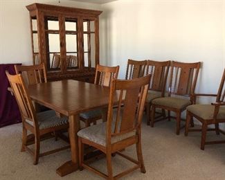 Beautiful Mission Style Dining Room: Table w 7 Side Chairs and 1 Captain's Chair and the Perfect Size Hutch w Glass Front Doors, Upholstered Seats are a nice neutral color