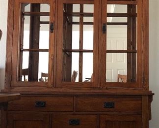 Beautiful Mission Style Dining Room: Table w 7 Side Chairs and 1 Captain's Chair and the Perfect Size Hutch w Glass Front Doors, Upholstered Seats are a nice neutral color