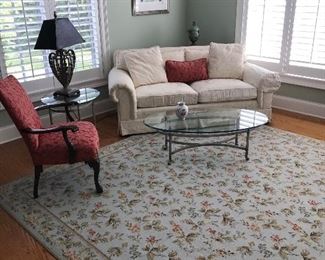 Walter E Smithe Sofa, Glass and wrought Iron Oval Coffee and Round End Table. Area Rug, Decorative Vases and Clock