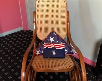 Old rocking chair and military flags. 