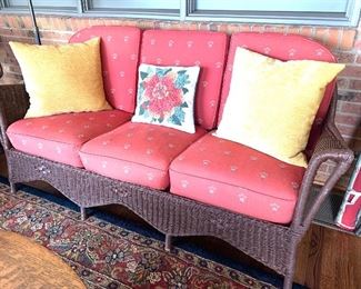 One of two, antique brown wicker sofas