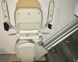 Acorn stairlift with single rail track that is mounted to your staircase. Seat, arm rests, seatbelt, footrest, all folds up.