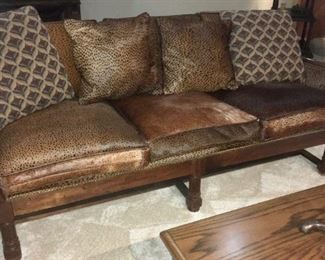 Wood frame, leather and animal hide sofa. Loads of authentic African artifacts, decorative pieces, artwork, as well as Anheuser-Busch memorabilia, glassware, etc.