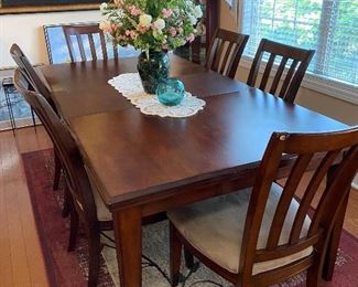 Dining table and 6 chairs. Shown with the one leaf inserted.