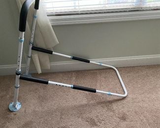 Adjustable bed rail that goes between the mattress and boxsprings of the bed