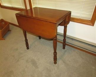 Small-size drop leaf table with lighter cherry finish. 18.5" deep x 28" wide x 29.5" tall. PRICE: $95.00