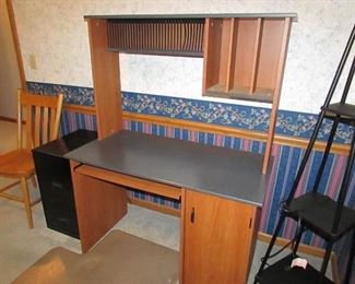 Laminate computer desk with CD rack. 42" tall x 20" deep x 28" wide. PRICE: $40.00
