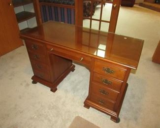 Small desk with cherry finish and custom glass top. 50" wide x 30" tall x 22" deep. PRICE: $125.00