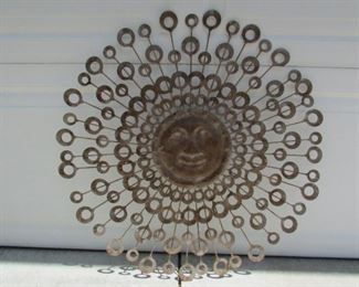 Metal hanging sun plaque. Approximately 26" diameter. PRICE: $35.00.