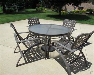 "Winston" outdoor patio table with umbrella base, (4) chairs, and umbrella. Umbrella has light wear. Chairs do come with the cushions that are seen in the additional pictures. Table is 4" diameter x 28" tall and has a clear non-breakable top; Each chair is 25.5" w x 35" tall x 29.5" deep. Umbrella is approximately 82" in diameter. PRICE FOR SET (table, chairs, base, cushions, umbrella): $300.00 for set.