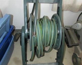 Green "SunCast" hose and reel. Approximately 24" w x 32" h x 20" deep. PRICE: $20.00
