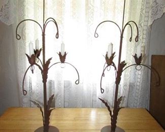 Pair of ornate heavy cast metal candelabras. 33" tall without candle x 12" wide x 6" diameter base. Can hang seasonal decor from the loops throughout the seasons or leave empty. PRICE FOR PAIR: $95.00.